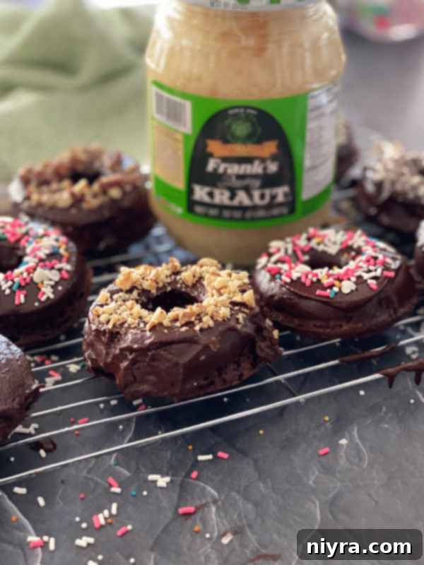 Chocolate Kraut donuts on a cooling rack, lightly glazed.