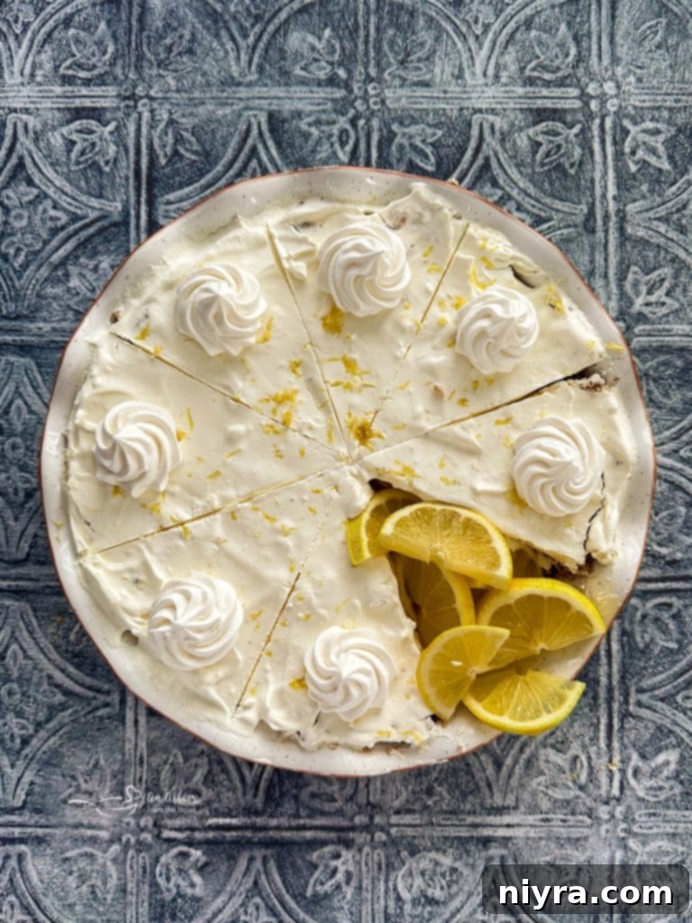 A slice of No-Bake Lemon Icebox Pie with a fork taking a bite.