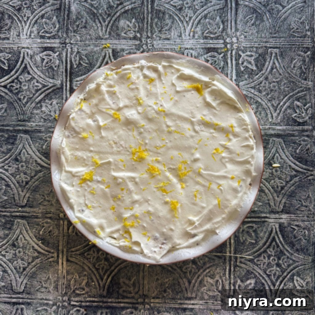 Pouring lemon pie filling into a graham cracker crust.