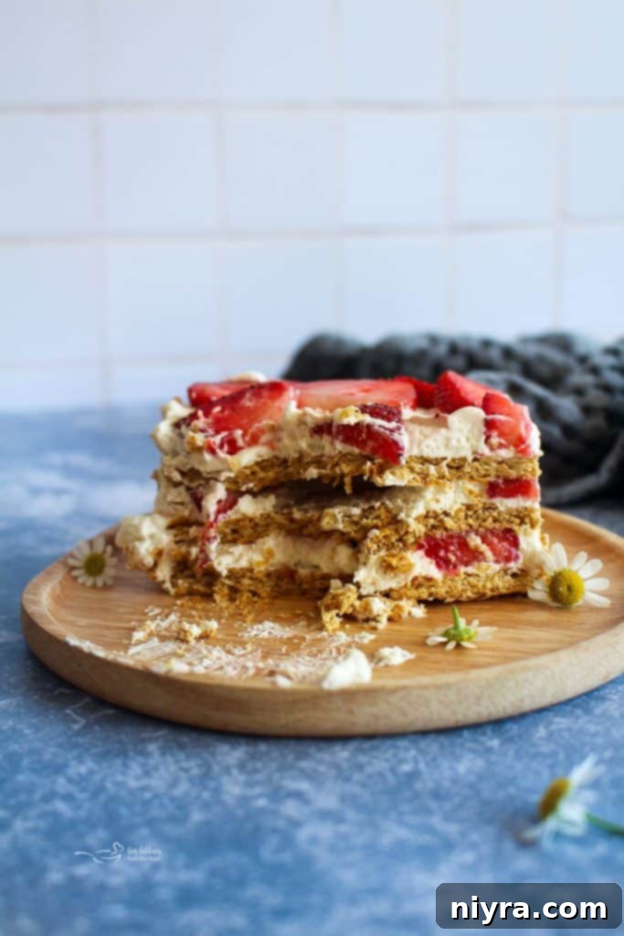 A piece of Strawberry Icebox cake with a bite out of it.