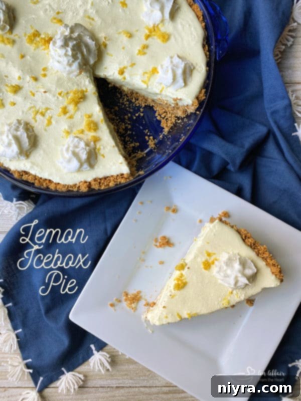 A single slice of Lemon Icebox Pie with a lime wedge.