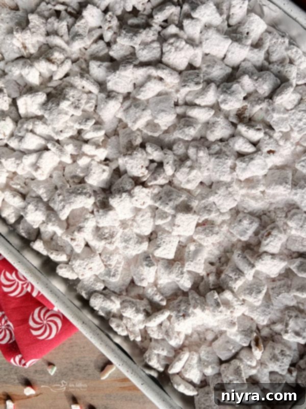 Candy Cane Puppy Chow Finished Finished candy cane puppy chow, beautifully coated in powdered sugar and ready to enjoy.