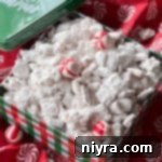 Peppermint Bark Puppy Chow 5 A box of candy cane puppy chow mix with peppermint, a perfect holiday treat.