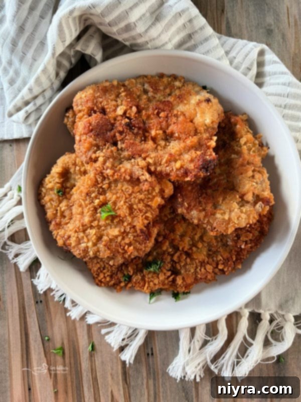 Crispy Breaded Pork Cutlets 2 Golden brown crispy breaded pork cutlets on a plate