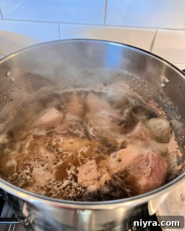 Pork Ribs simmering in a pot with beer and water