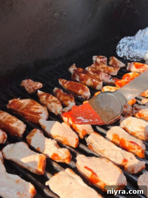 BBQ Pork Ribs grilling on an outdoor barbecue
