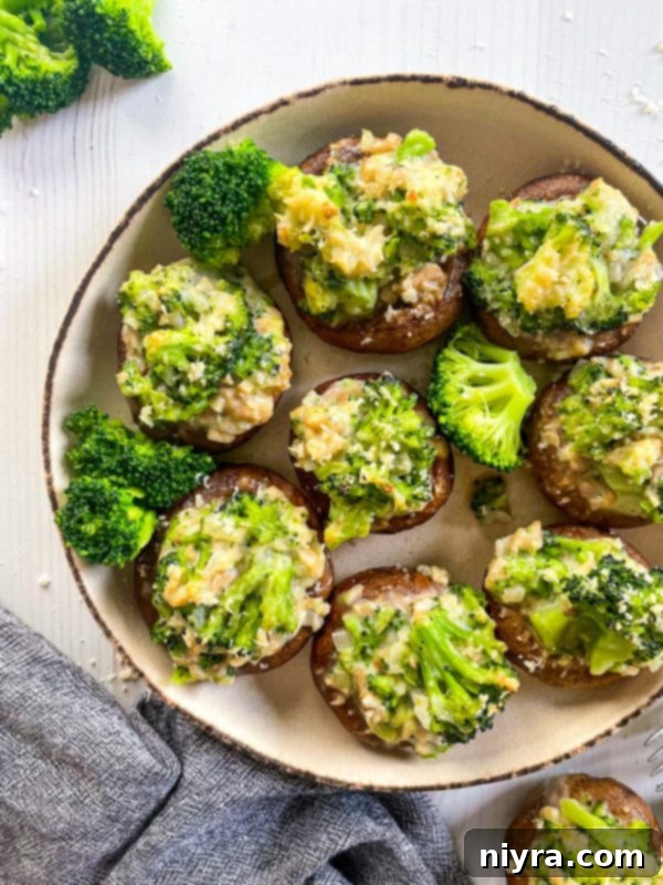 A plate of perfectly baked broccoli stuffed mushrooms, garnished and ready to serve.