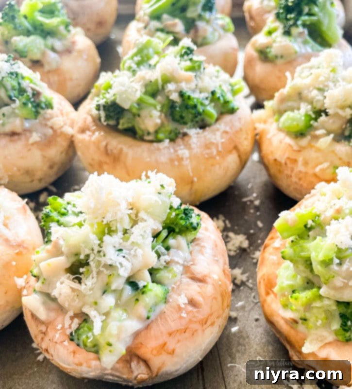 A close-up of a serving of baked stuffed mushrooms with broccoli and cheese, perfectly golden.