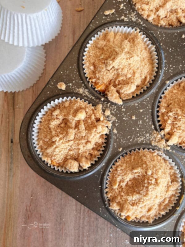 Muffin batter in tins with streusel
