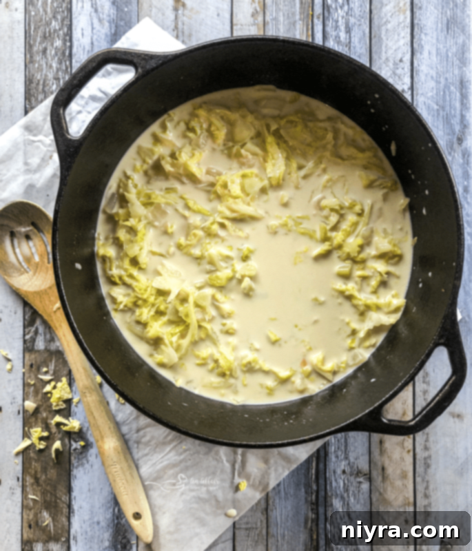 Cabbage and caraway seeds wilting in a Dutch oven.