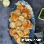 Homemade baked potato chips in a blue and white serving dish.