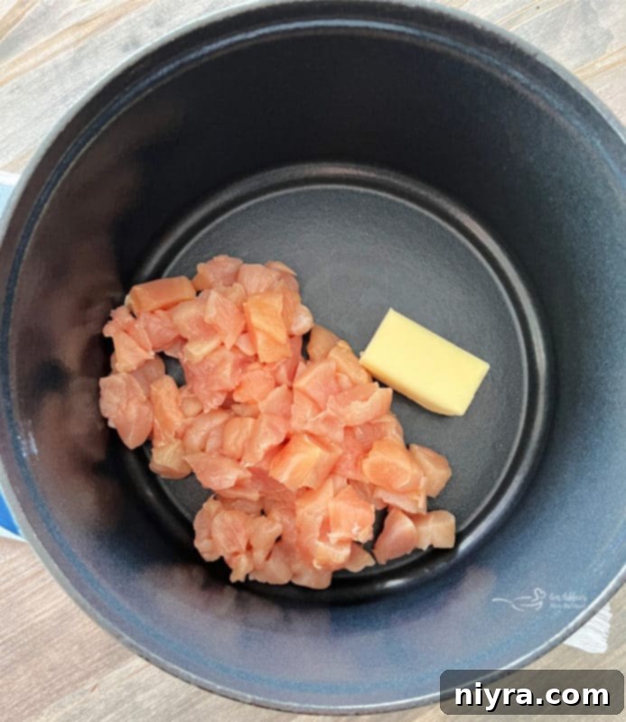 Cooking diced chicken in a pan with butter