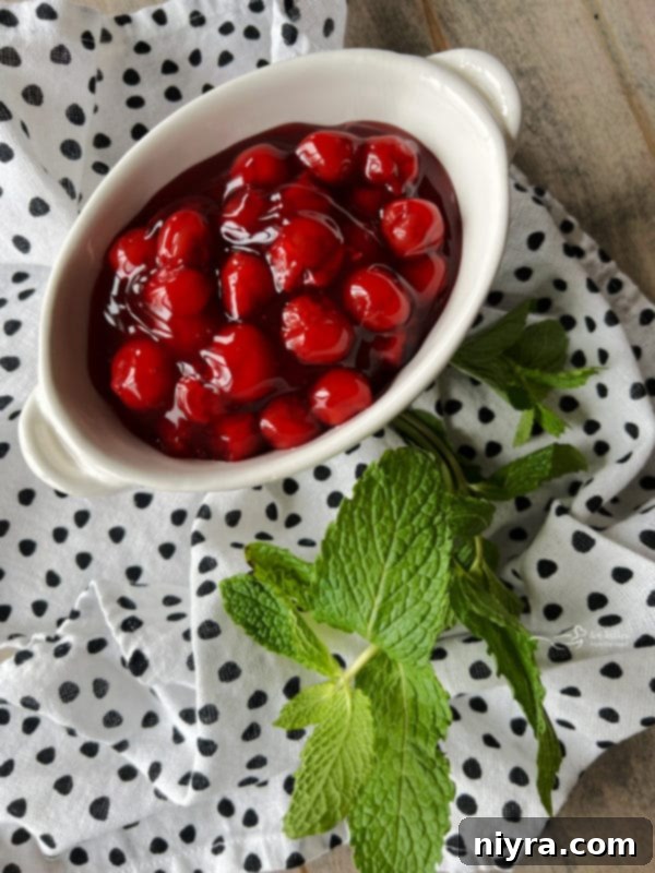 ice cream cake roll condiments, including fresh mint and cherry pie filling