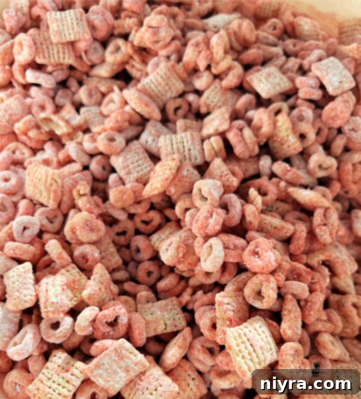 A close-up view of the strawberry Chex mix, showing the vibrant pink coating.