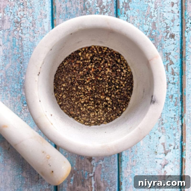 DIY Lemon Pepper Perfection 7 Grinding black peppercorns in a spice grinder