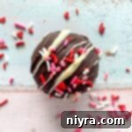 white chocolate drizzled and candy sprinkled hot chocolate bomb