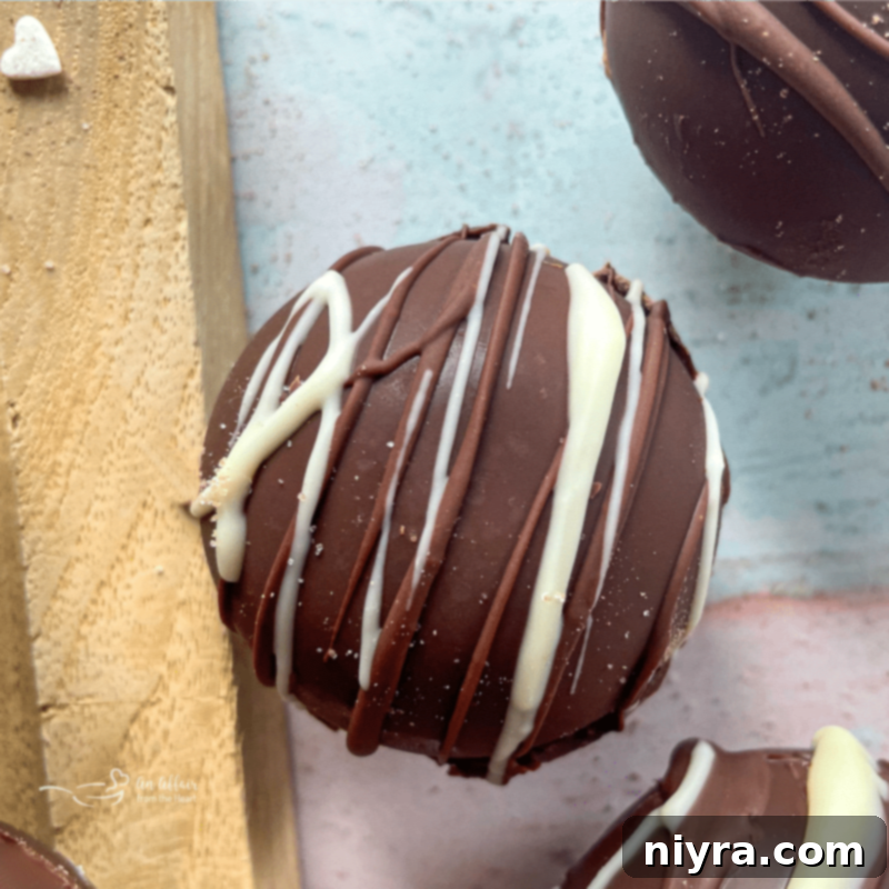 hot cocoa bomb drizzled with white chocolate