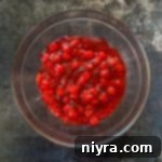 Adding the Cherry Pie filling to the Jello.