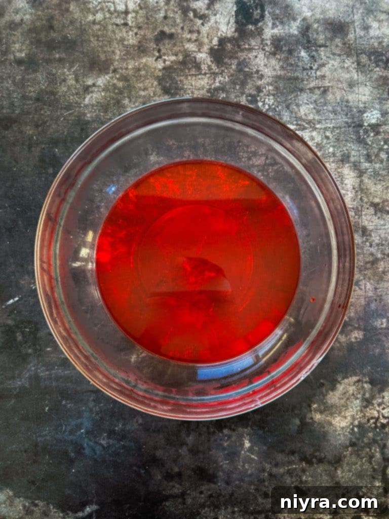 Step one: Dissolving Jell-O powder in boiling water in a large bowl.