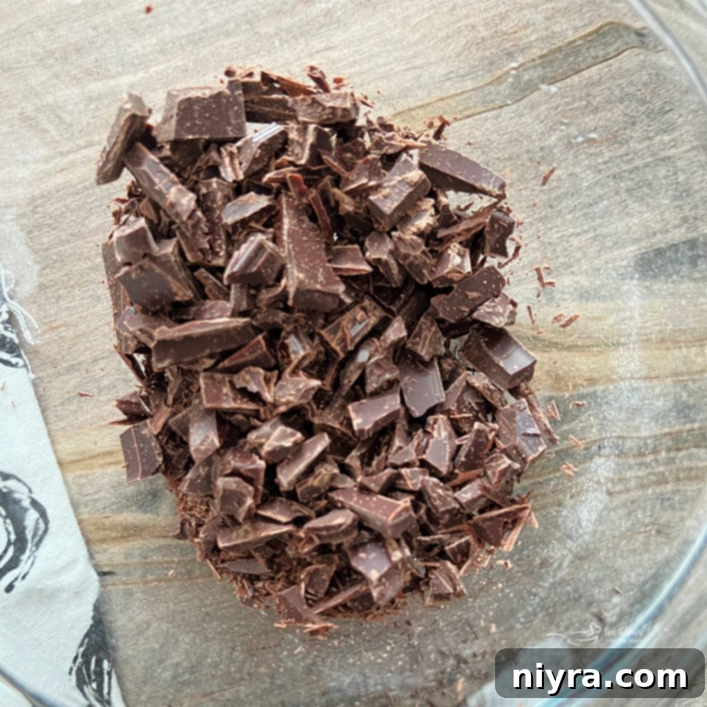 Finely chopped German chocolate pieces in a bowl, ready to be melted for the cake batter.
