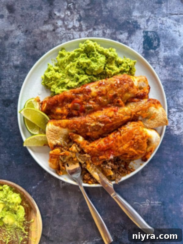 Plate of Ground Beef Enchiladas with a fork
