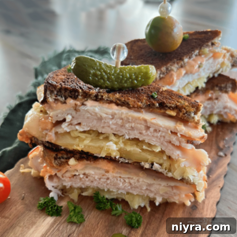 Perfectly golden Turkey Reuben Sandwich cut in half