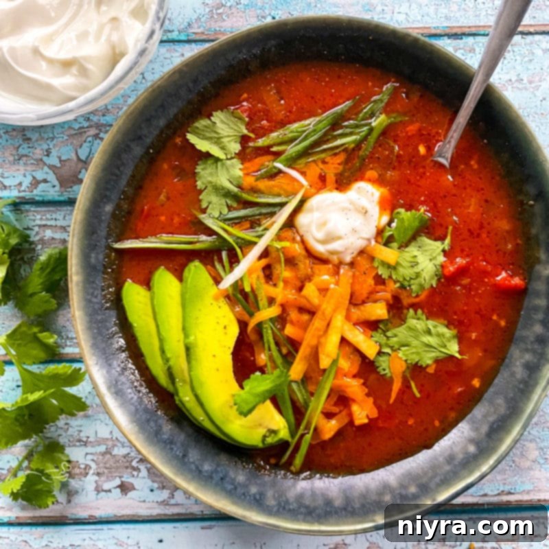 A ceramic bowl filled with homemade tortilla soup, ready to be enjoyed.