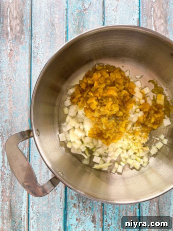 Sautéing onions, green chilies, and garlic in a pot for tortilla soup.