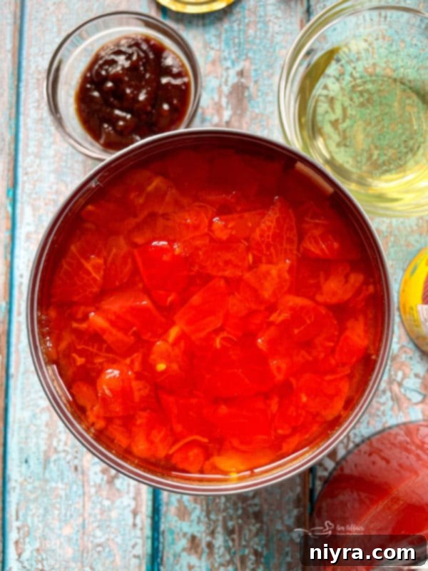Adding broth ingredients to a pot for tortilla soup.