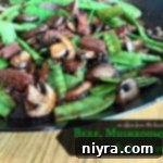 Close up of Asian Beef, Mushrooms and Snow peas in a wok