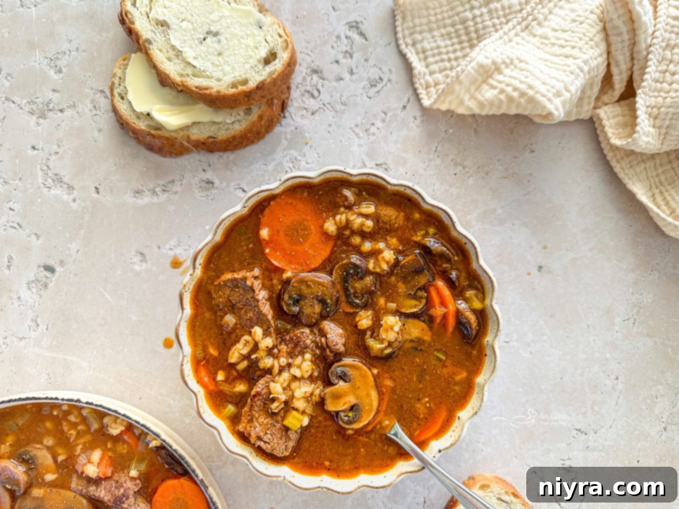 Close-up of Vegetable Beef Barley Soup with Mushrooms, showing the rich broth and diverse ingredients.