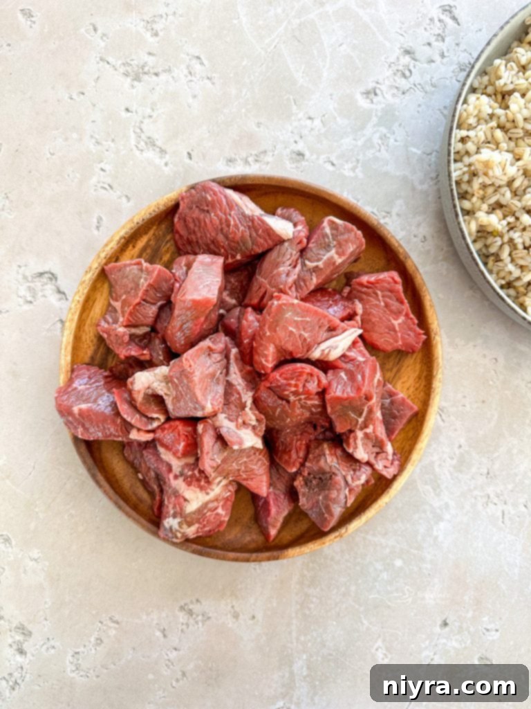 Prepped vegetables and mushrooms for Vegetable Beef Barley Soup, including carrots, celery, shallots, and garlic.