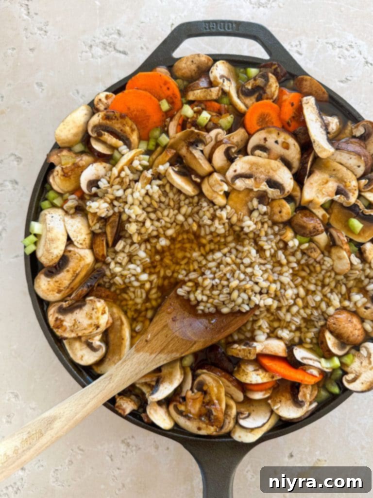 Beef stew meat coated in flour, salt, and pepper, ready for browning in a stockpot.