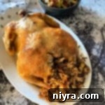 Golden Baked Chicken with Savory Wild Rice Stuffing 12 Baked Chicken & Wild Rice on a white serving platter
