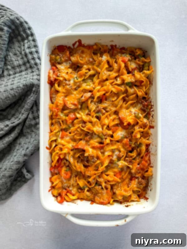 Pizza and Pasta Perfection 11 Pizza Pasta Casserole ready for baking, topped with cheese