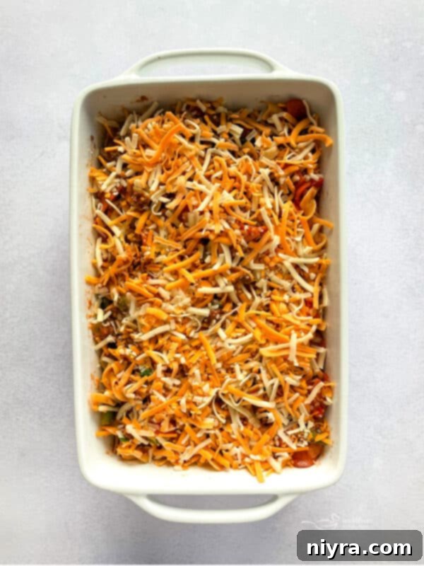 Pizza and Pasta Perfection 10 Mixing pasta and cheese into the pizza sauce mixture