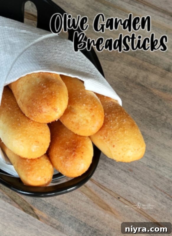 Freshly baked Olive Garden Breadsticks on a baking rack, cooling down