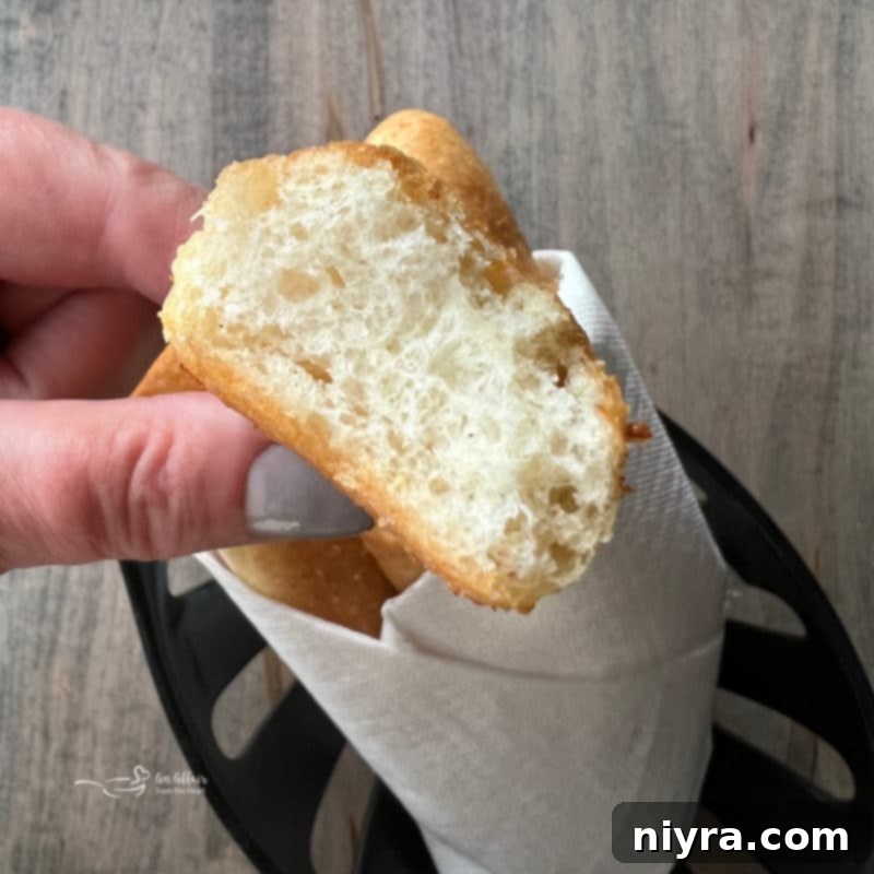 Pulled apart Olive Garden Breadsticks showing their fluffy interior