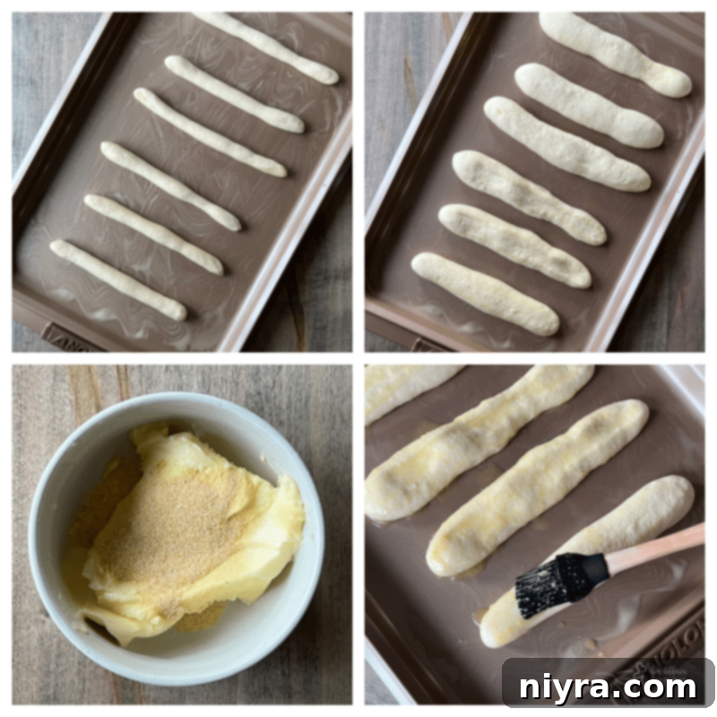 Brushing the tops of the breadsticks with garlic butter before baking