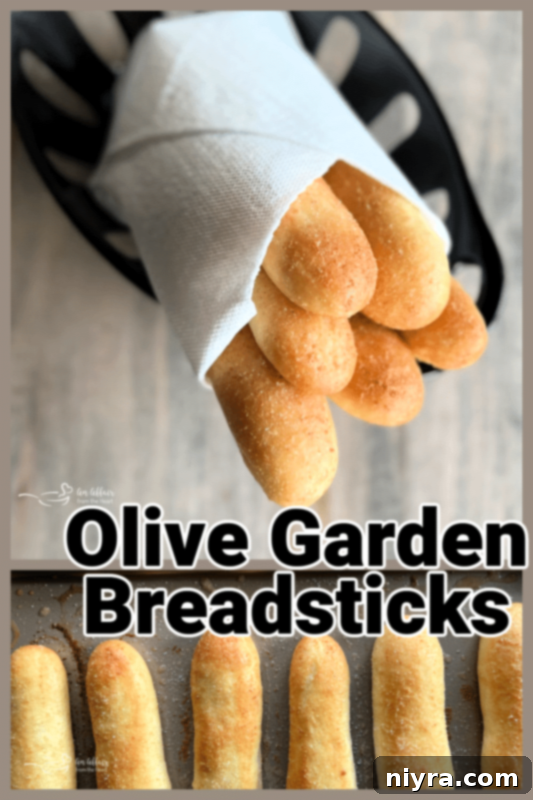 Olive Garden Breadsticks on a wooden board with a side of marinara sauce