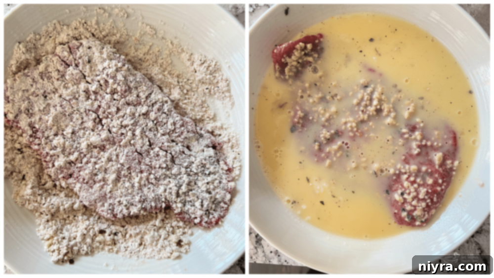 Close-up of cube steaks being coated in a seasoned flour mixture.