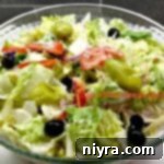 Copy cat Olive Garden Salad in a clear serving bowl