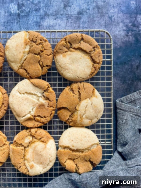 Freshly baked Gingerdoodle Cookies cooling on a wire rack, showcasing their inviting golden color and soft centers.