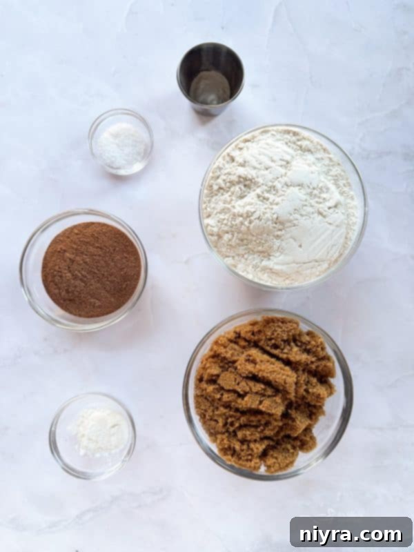A plate of Malted Chocolate Chip Cookies, with some crumbs and chocolate chips scattered around