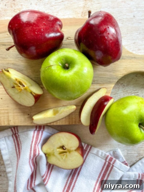 green and red apples on cutting board