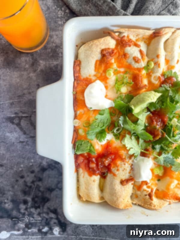 A close-up shot of Golden Brown Brunch Enchiladas with Ham, garnished with fresh cilantro, ready to serve.