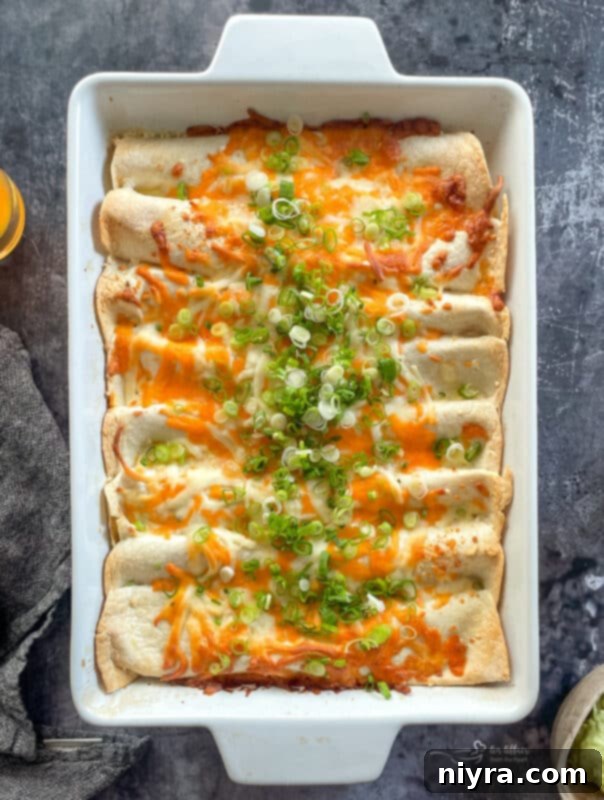 Golden brown, bubbling ham and cheese enchiladas fresh out of the oven, steam rising invitingly.