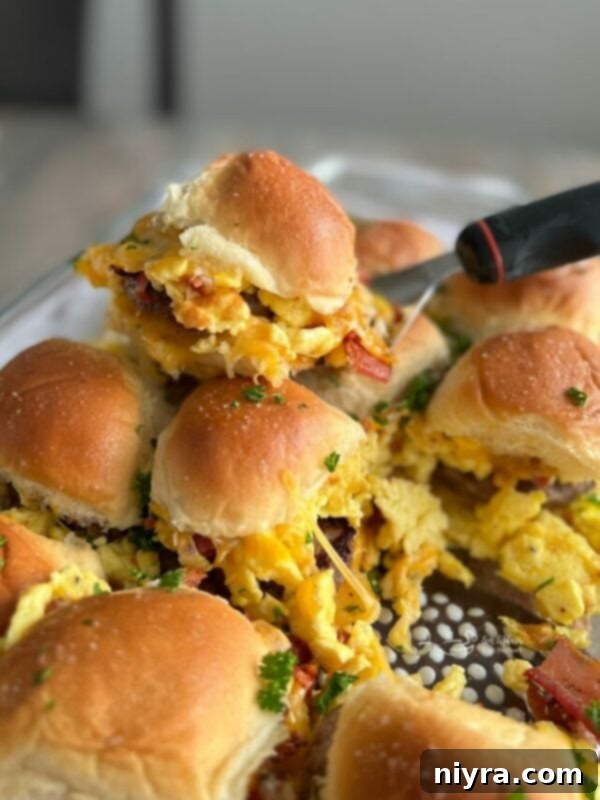 Close view of savory sausage egg sliders with melted cheese, a perfect quick breakfast idea.