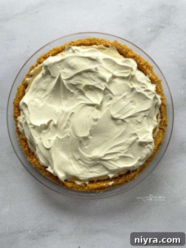 Topping the No-Bake Peanut Butter Pie with Remaining Cool Whip