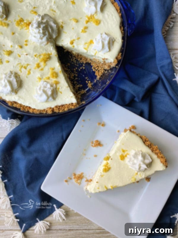 Overhead shot of a whole Lemon Icebox Pie and a slice on a white plate